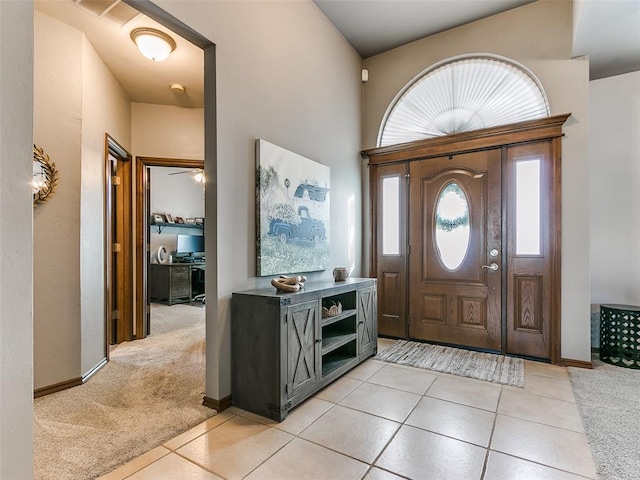 view of carpeted foyer entrance