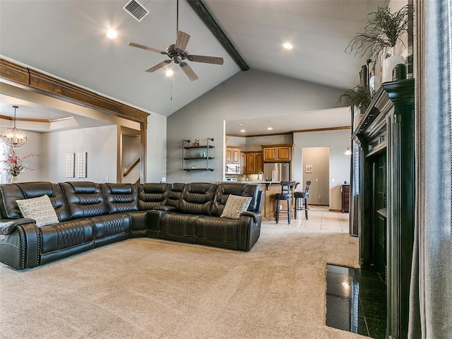 living room with ceiling fan with notable chandelier, high vaulted ceiling, light colored carpet, and beam ceiling