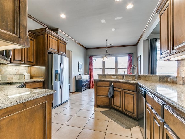 kitchen with sink, crown molding, appliances with stainless steel finishes, light stone counters, and decorative backsplash