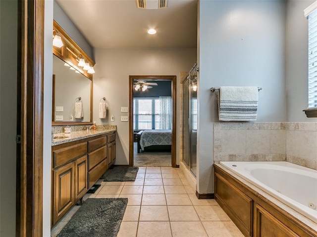 bathroom with ceiling fan, vanity, plus walk in shower, and tile patterned flooring