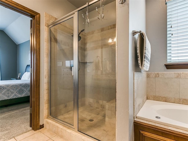 bathroom featuring vaulted ceiling, tile patterned floors, and shower with separate bathtub