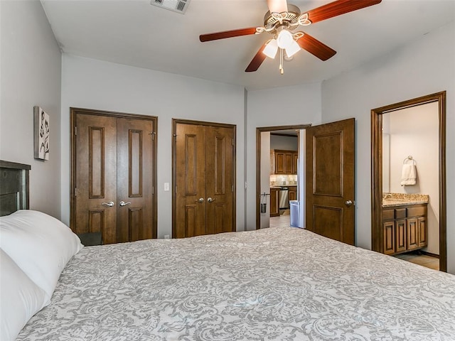 bedroom with multiple closets, ceiling fan, and ensuite bathroom