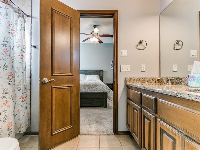 bathroom featuring ceiling fan, vanity, a shower with curtain, tile patterned floors, and toilet