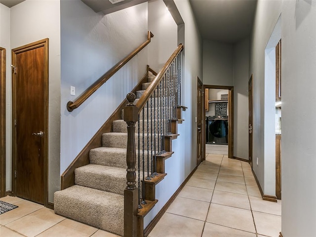 staircase featuring washer / clothes dryer and tile patterned floors