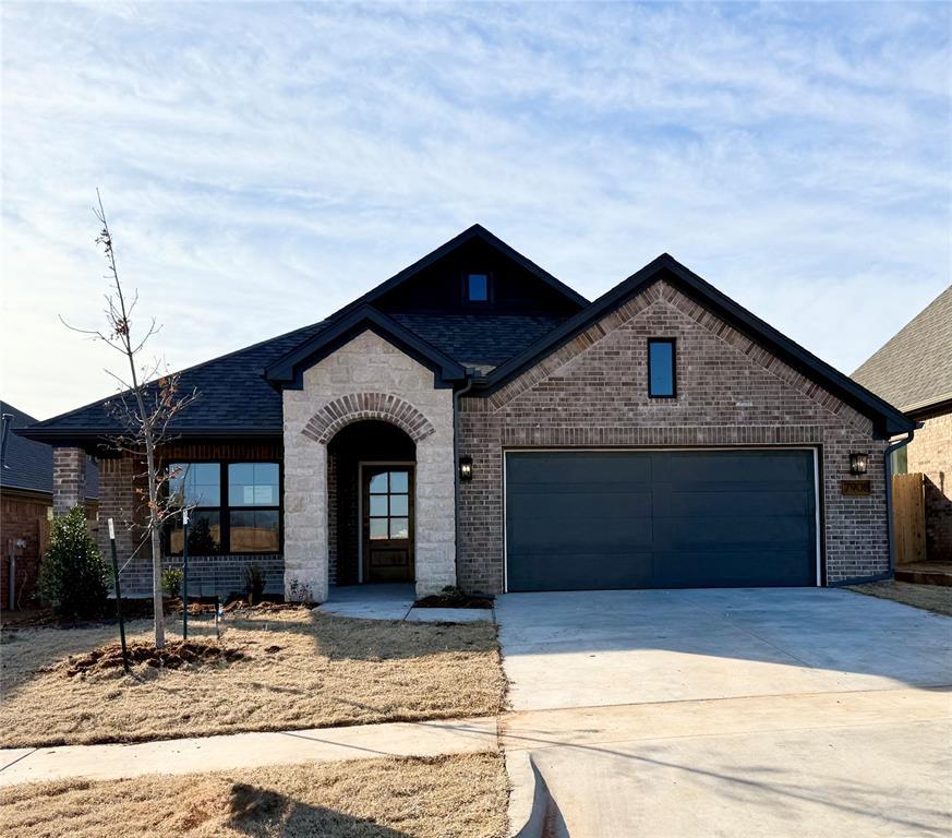 french country inspired facade with a garage