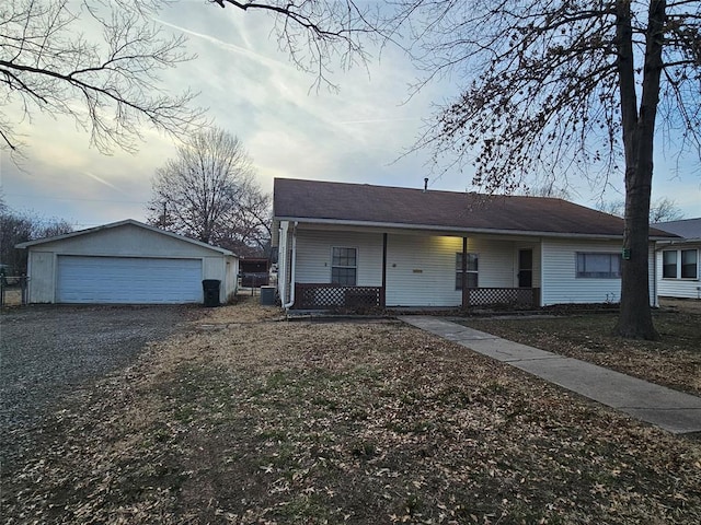 view of front of property featuring a garage, an outdoor structure, cooling unit, and covered porch