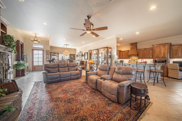 tiled living room with ceiling fan and ornamental molding