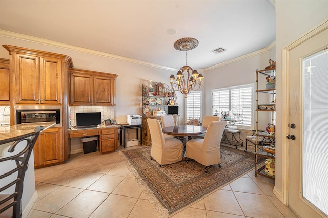 tiled dining space featuring crown molding and a notable chandelier