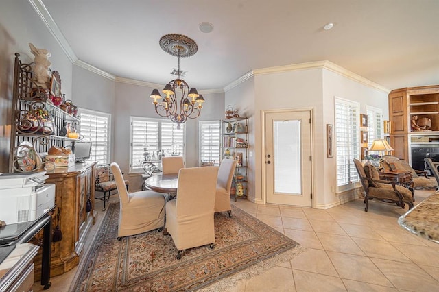 dining room with light tile patterned flooring, ornamental molding, and a notable chandelier