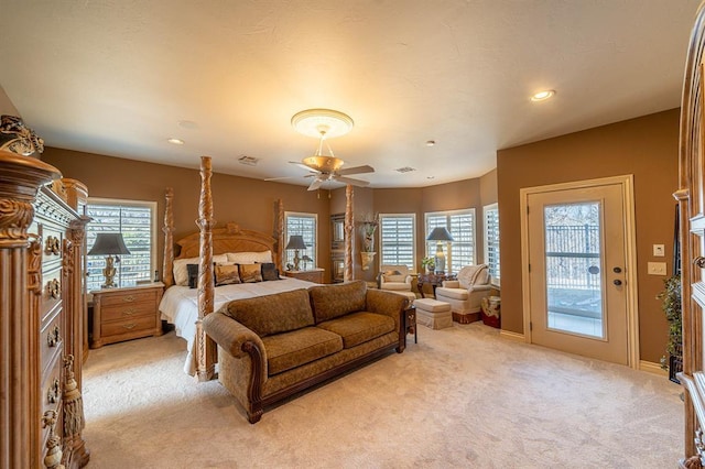 bedroom featuring access to outside, light colored carpet, and ceiling fan