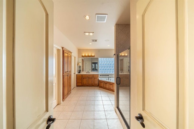 bathroom with tile patterned flooring, vanity, and separate shower and tub