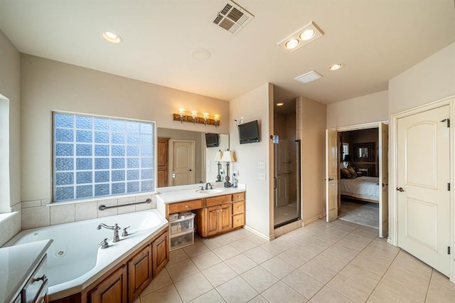 bathroom with tile patterned flooring, vanity, and independent shower and bath