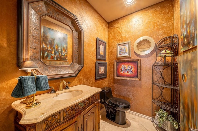 bathroom featuring tile patterned floors, toilet, and vanity