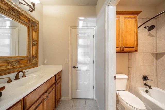 full bathroom featuring tiled shower / bath, vanity, toilet, and tile patterned flooring