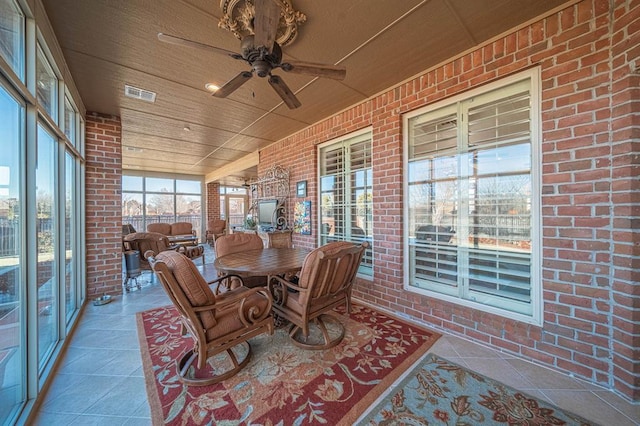 sunroom with ceiling fan and wood ceiling