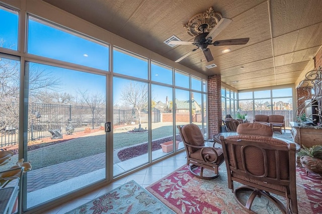 sunroom / solarium featuring ceiling fan and wood ceiling