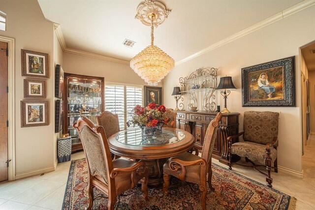 dining room featuring a chandelier, baseboards, visible vents, and crown molding