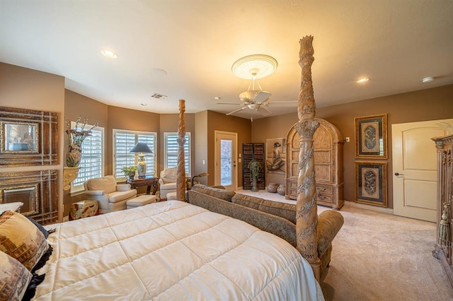 bedroom with recessed lighting, a fireplace, visible vents, and light colored carpet