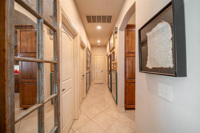 hallway with recessed lighting, visible vents, and light tile patterned floors