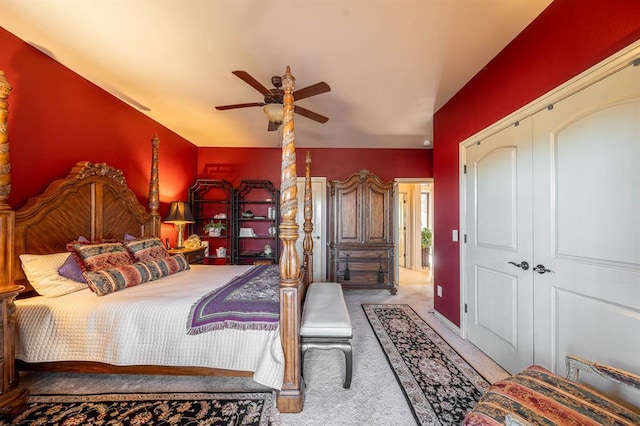 bedroom featuring a closet, a ceiling fan, and light colored carpet