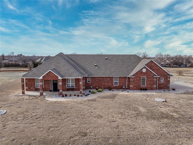 rear view of property featuring a lawn and a patio area