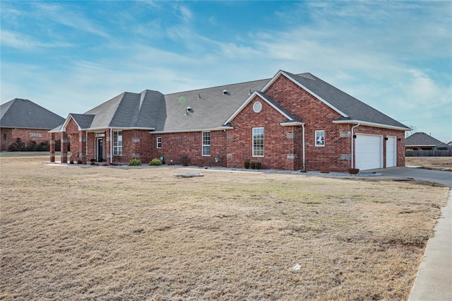 view of front facade with a garage and a front lawn