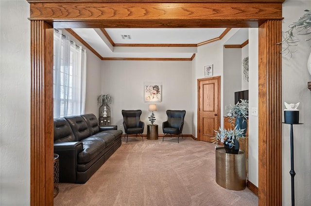 sitting room with ornamental molding and carpet