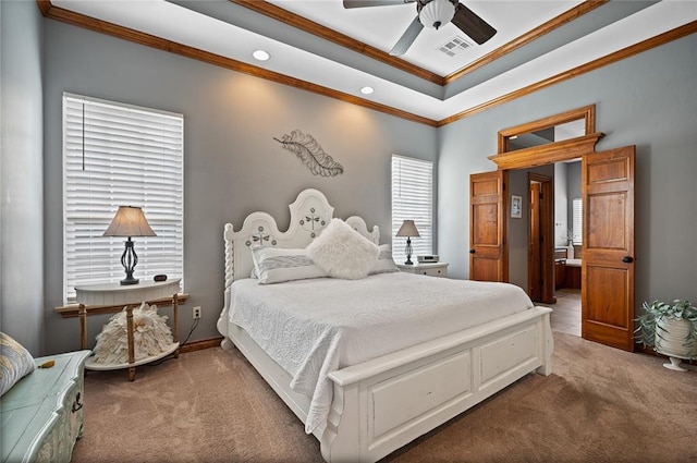 carpeted bedroom with a raised ceiling, crown molding, and ceiling fan