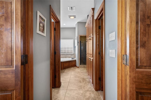 hall with light tile patterned flooring