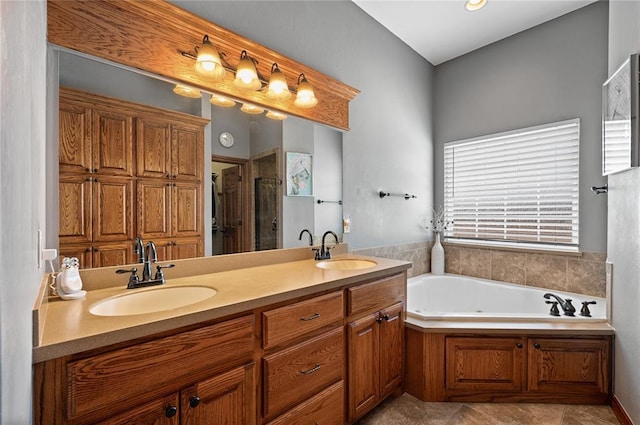 bathroom featuring vanity and independent shower and bath