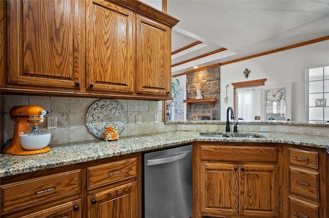 kitchen featuring light stone counters, sink, a healthy amount of sunlight, and dishwasher