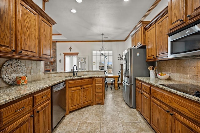 kitchen featuring pendant lighting, sink, stainless steel appliances, light stone counters, and ornamental molding