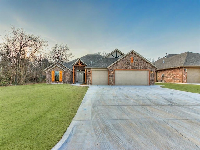 view of front of home featuring a garage and a yard