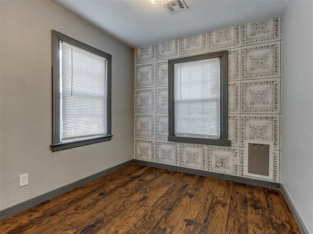 spare room with dark wood-type flooring