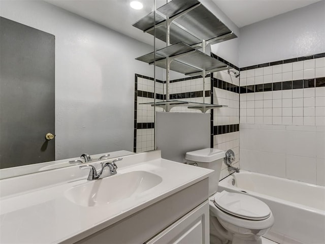 full bathroom with vanity, toilet, and tiled shower / bath combo