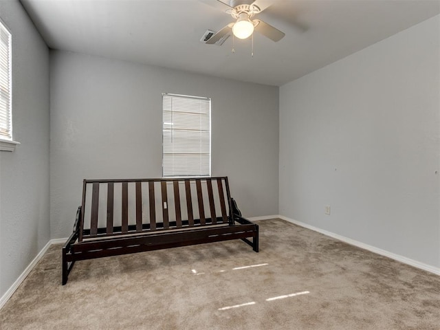 carpeted bedroom with multiple windows and ceiling fan