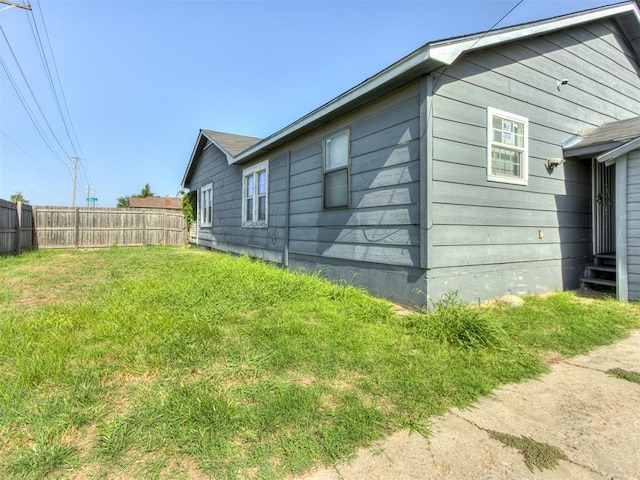 view of side of property with a yard