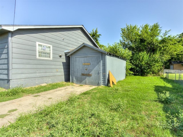 view of outdoor structure featuring a lawn