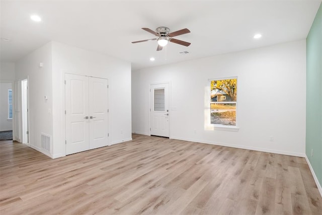 unfurnished room with ceiling fan and light wood-type flooring