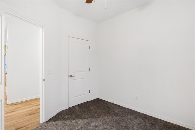 carpeted spare room with ceiling fan