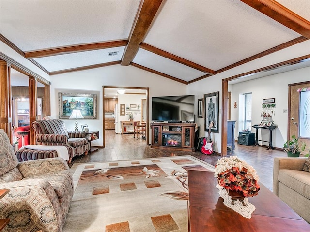 living room featuring lofted ceiling with beams and wood-type flooring