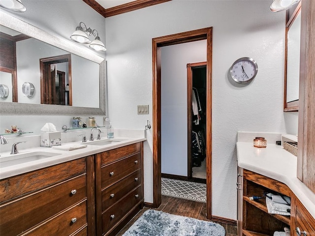 bathroom with vanity, crown molding, and wood-type flooring