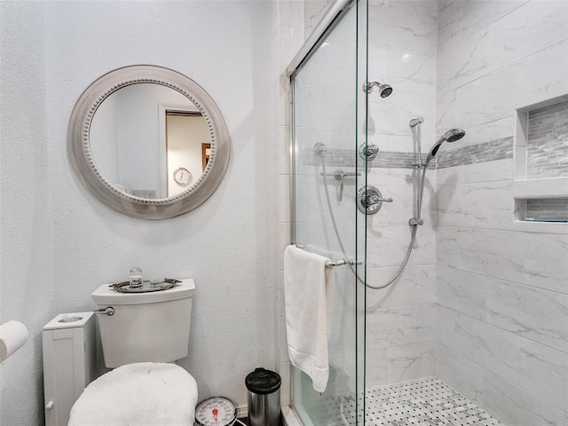 bathroom with toilet and walk in shower