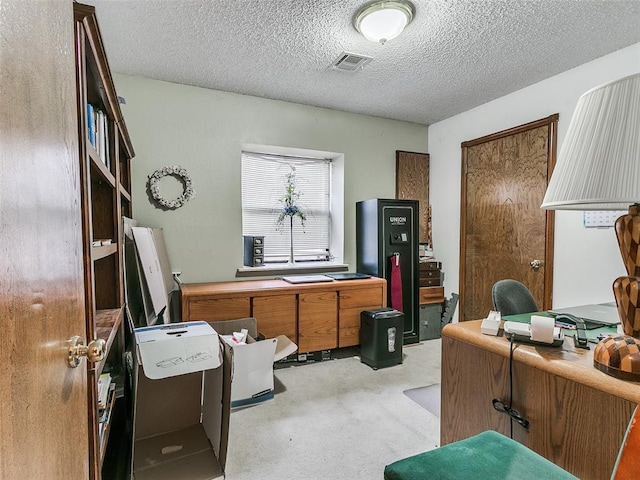 office area featuring light colored carpet and a textured ceiling