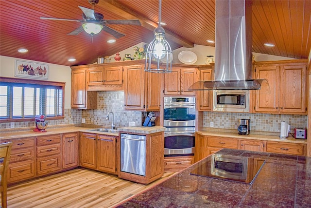 kitchen with appliances with stainless steel finishes, decorative light fixtures, lofted ceiling with beams, sink, and island exhaust hood