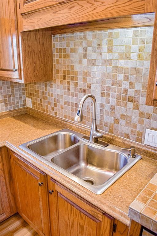 kitchen featuring tasteful backsplash and sink