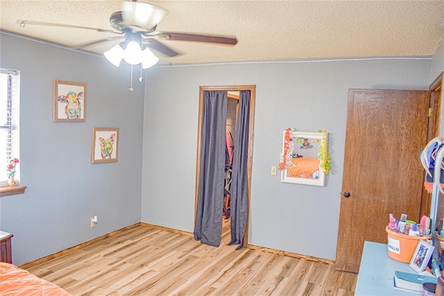 bedroom featuring light hardwood / wood-style flooring and a textured ceiling