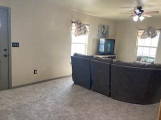 unfurnished living room with carpet floors and ceiling fan