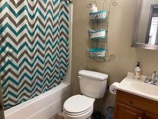 full bathroom with vanity, shower / bath combination with curtain, and toilet