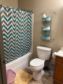 full bathroom with vanity, toilet, and shower / bath combo